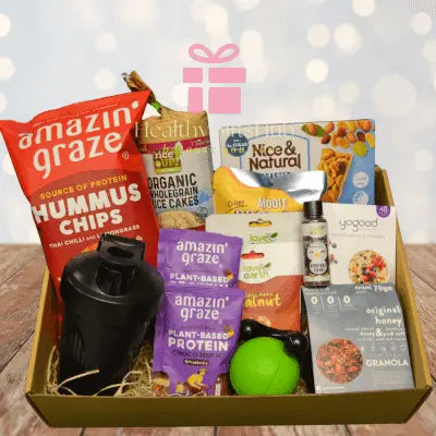 Open rustic gift box showcasing healthy snacks and treats